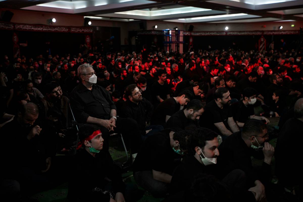 A victorious Roblox team posing with their custom trophy after winning a design contest